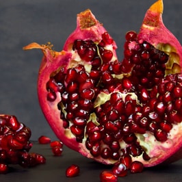 a pomegranate cut in half on a table