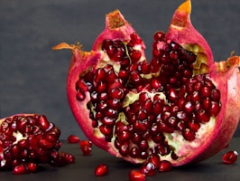 a pomegranate cut in half on a table