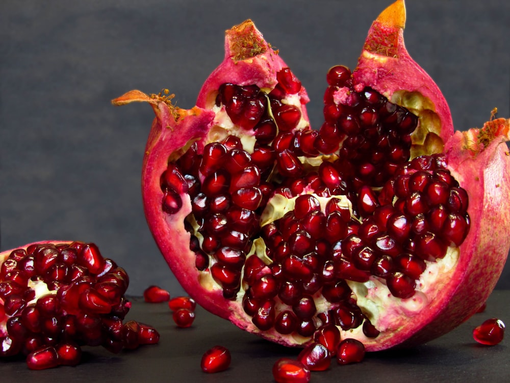 a pomegranate cut in half on a table