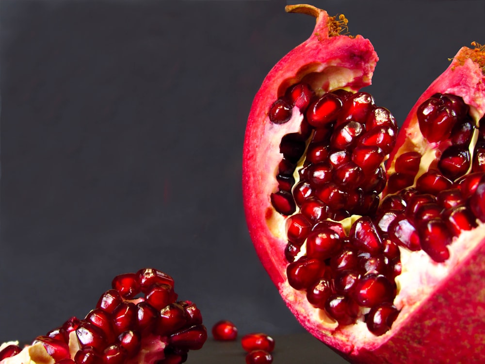 a pomegranate cut in half on a table