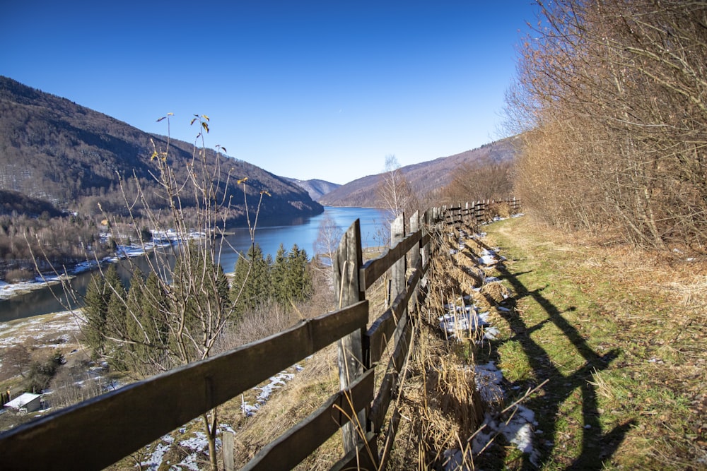 a wooden fence on the side of a mountain