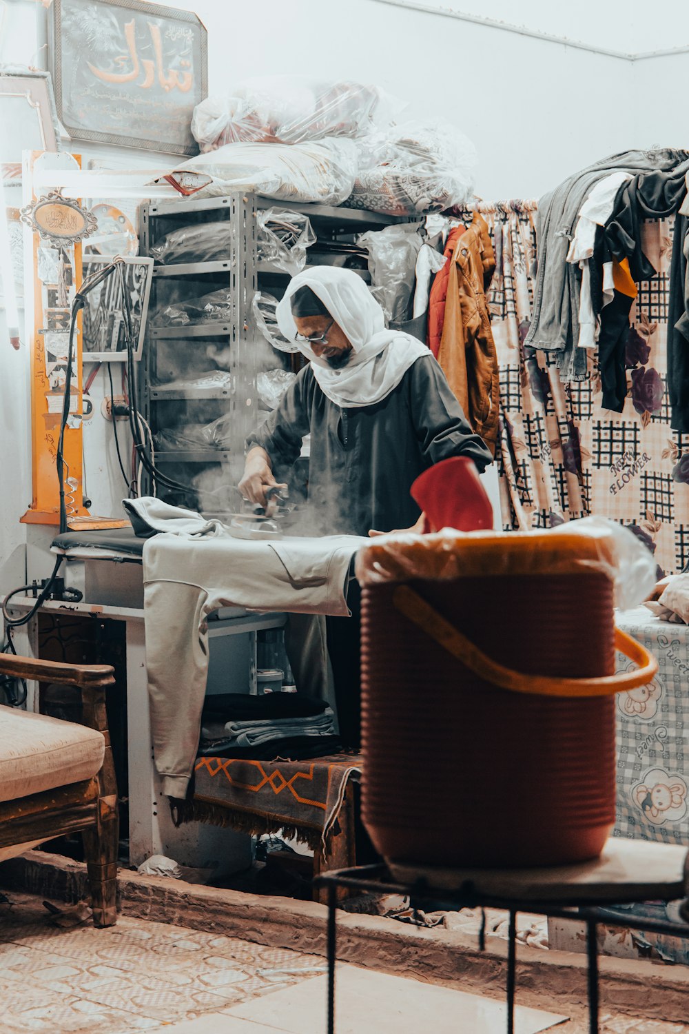 a woman in a kitchen cooking food on a stove