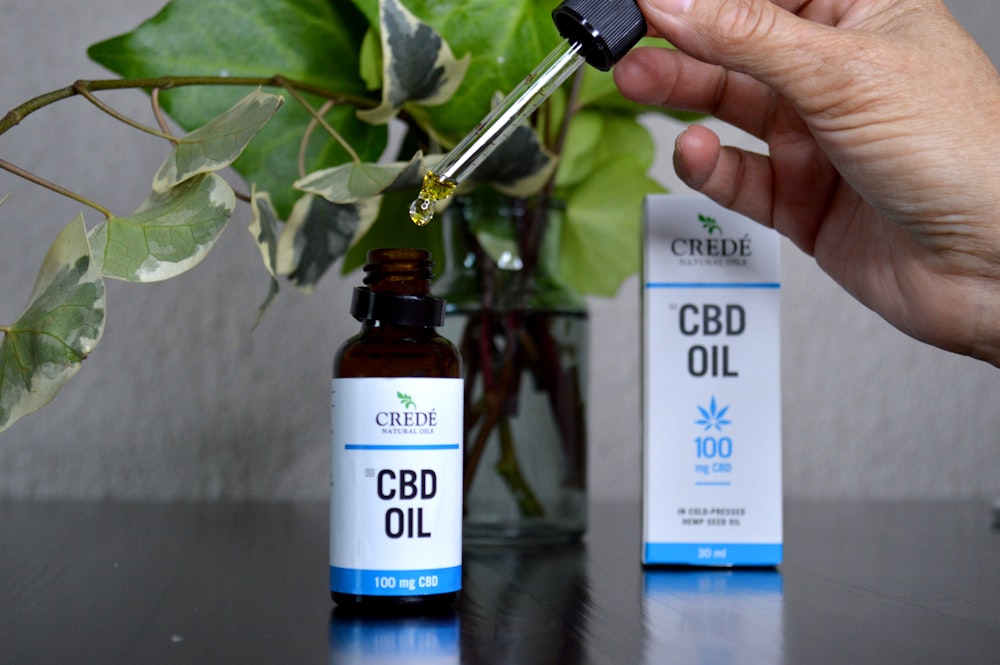 a bottle of cbd oil and a bottle of cbd oil on a table