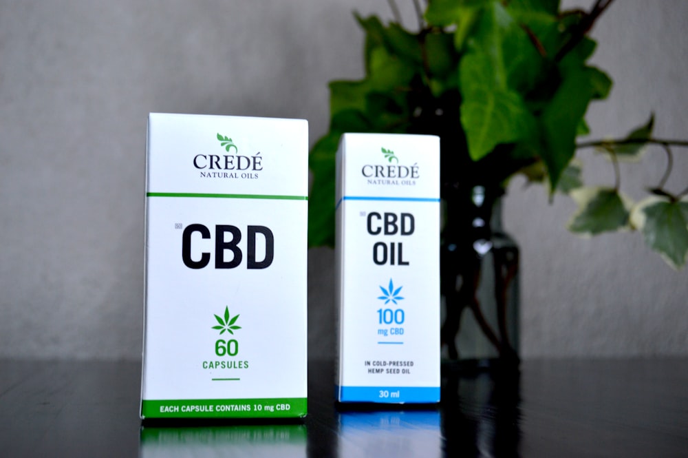 two boxes of cbd oil sitting on a table