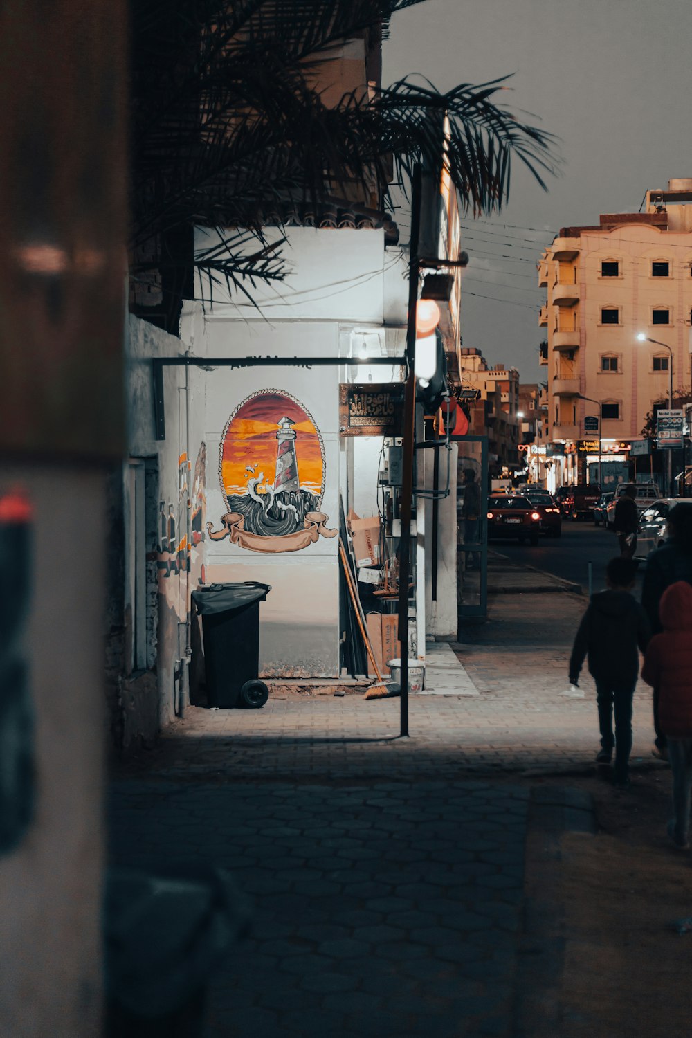 a couple of people walking down a street