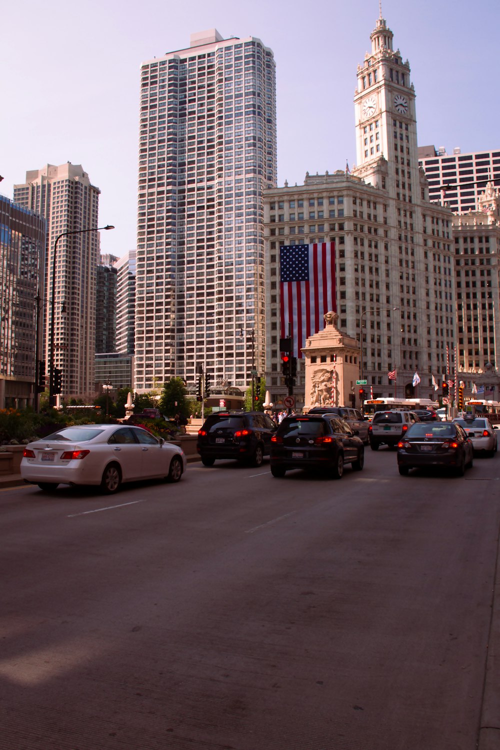 a city street filled with lots of traffic and tall buildings