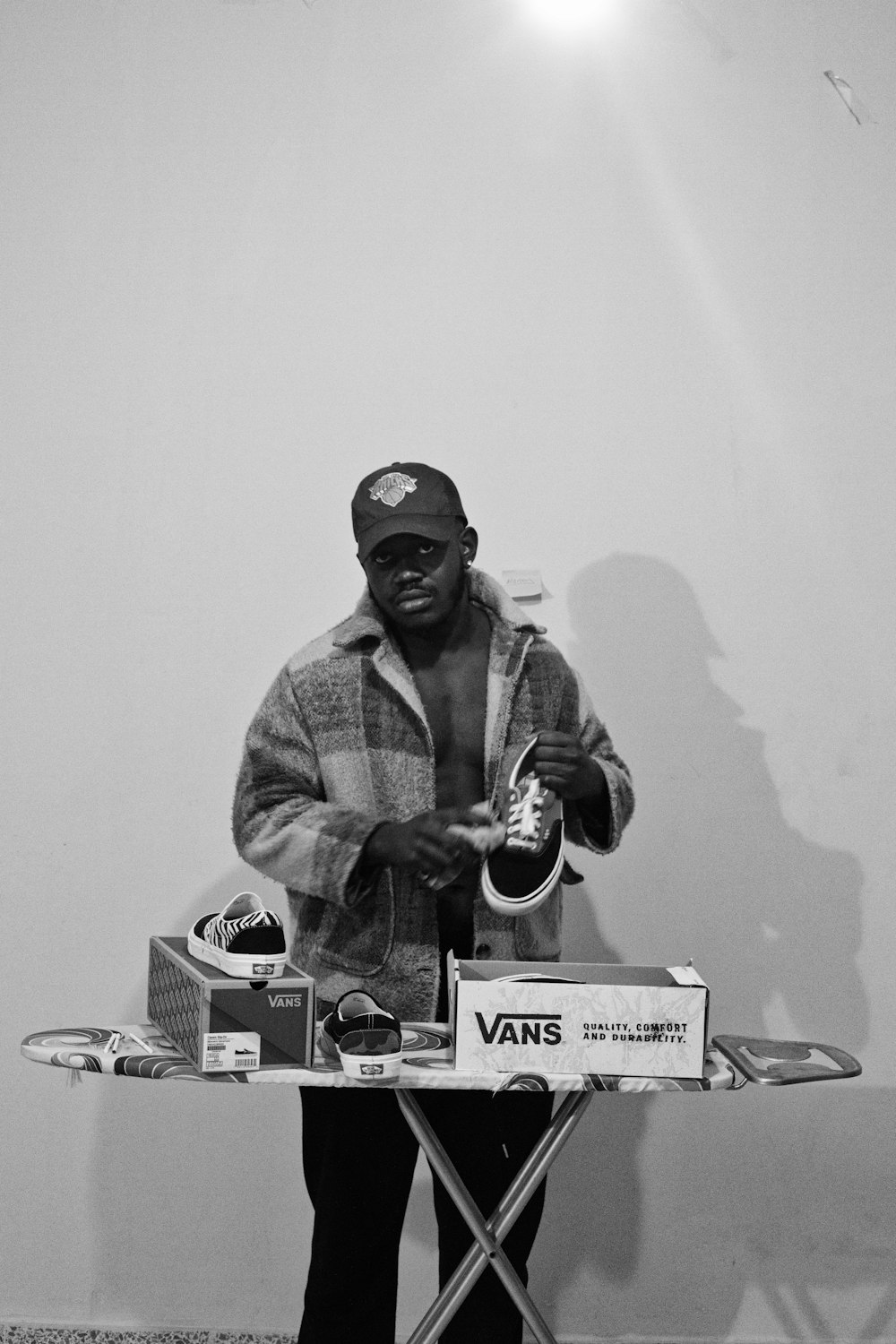 a man standing behind a table with a pair of skis on it