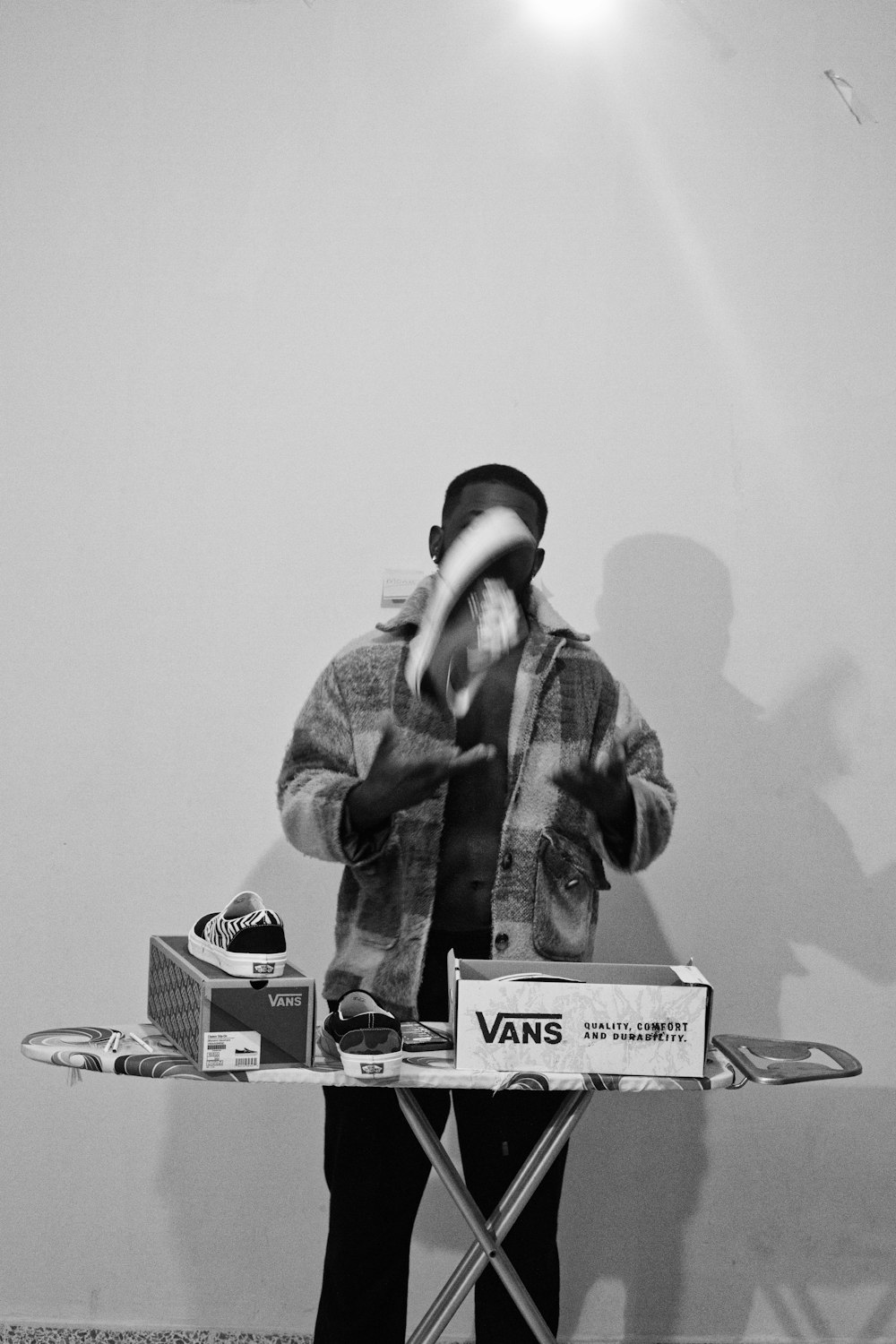 a man standing behind a table with a snowboard on it