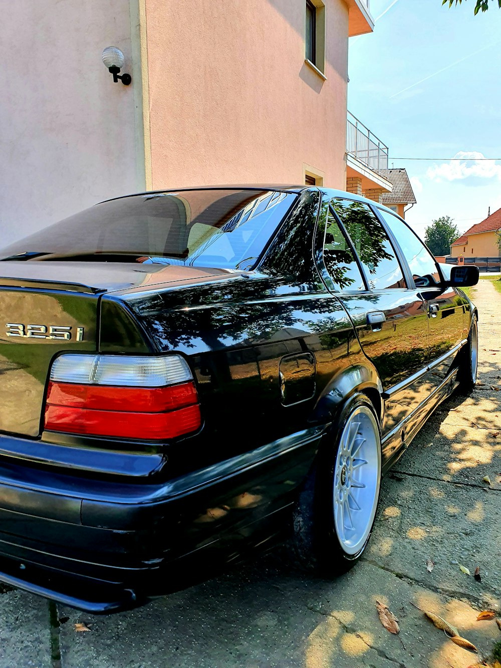 a black car parked in front of a building