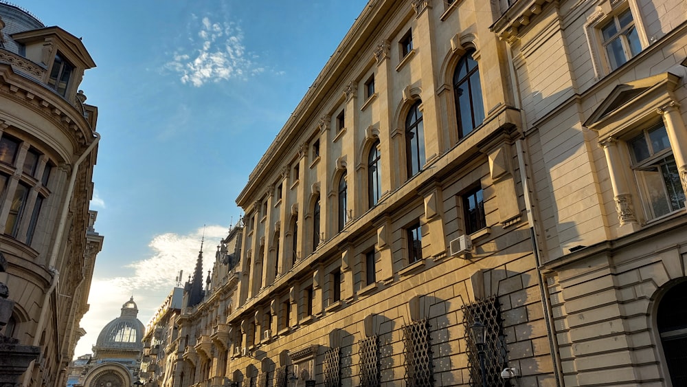 a row of buildings with a clock tower in the background