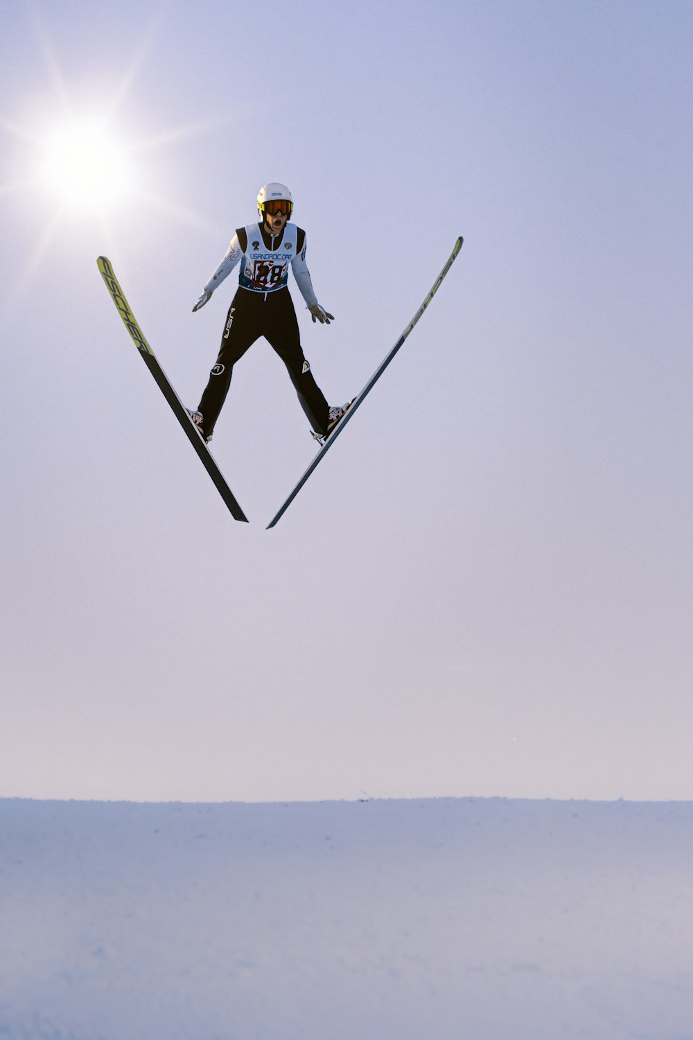 a man flying through the air while riding skis