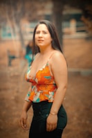 a woman in a floral top poses for a picture