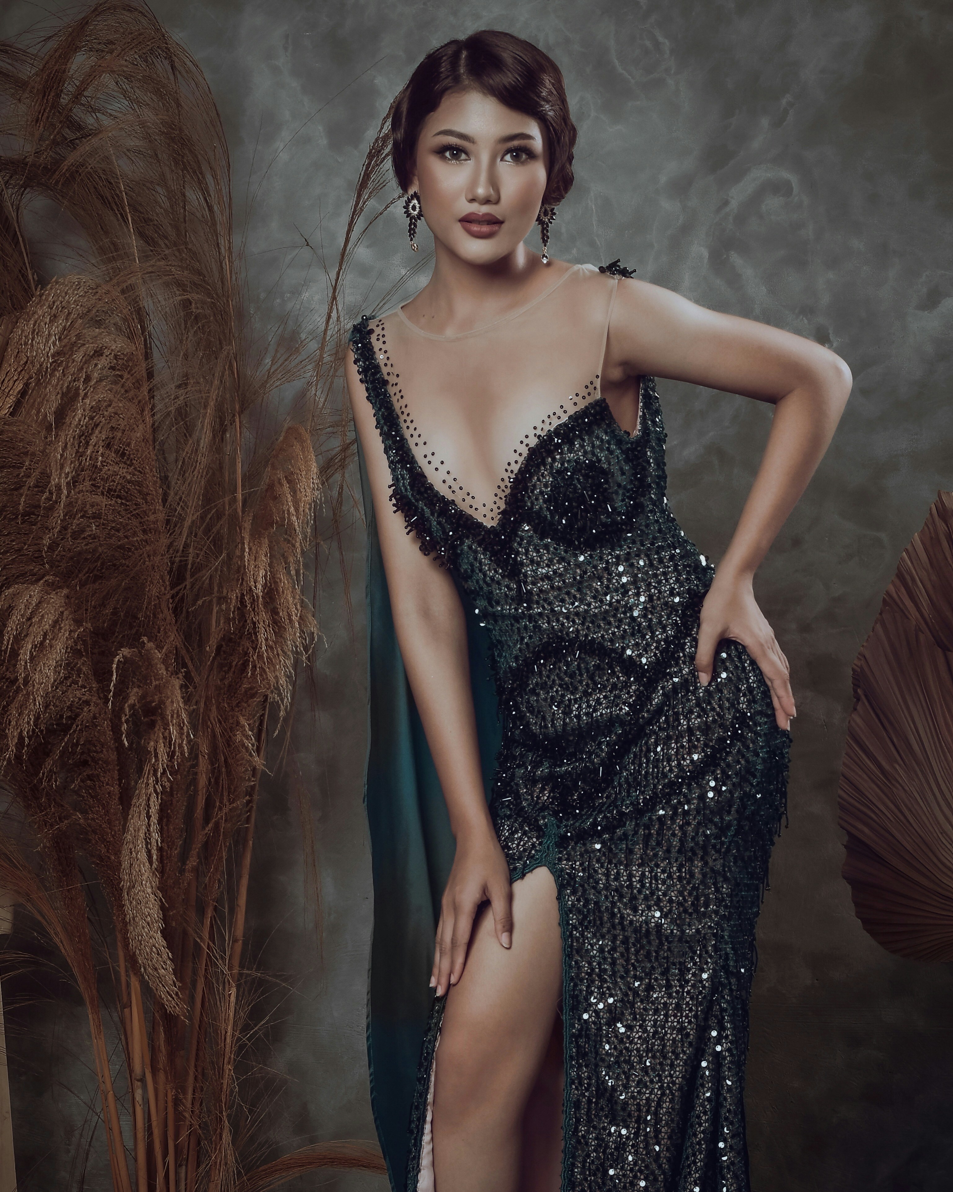 a woman in a black dress posing for a picture