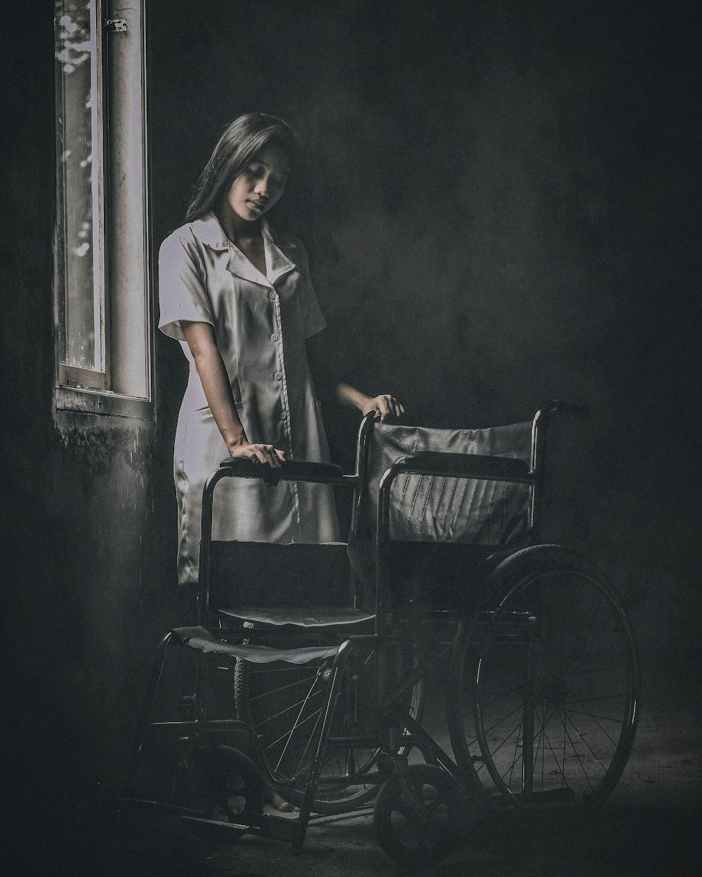 a woman standing next to a baby in a stroller