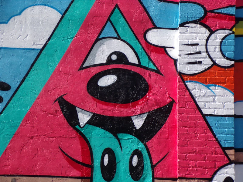 A wall painted with a cartoon dog and a triangle