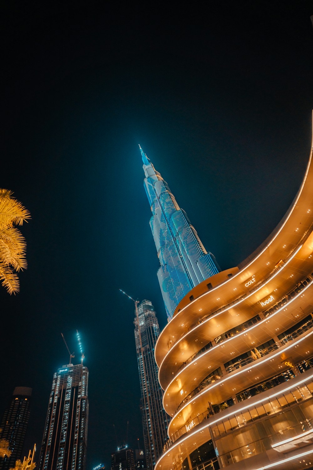 a night view of the burj building in the middle of the city