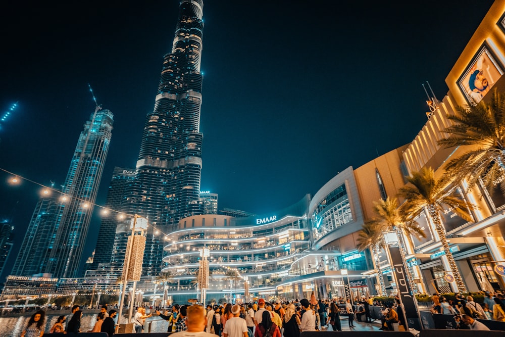 a group of people standing in front of a tall building