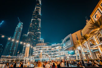 a group of people standing in front of a tall building