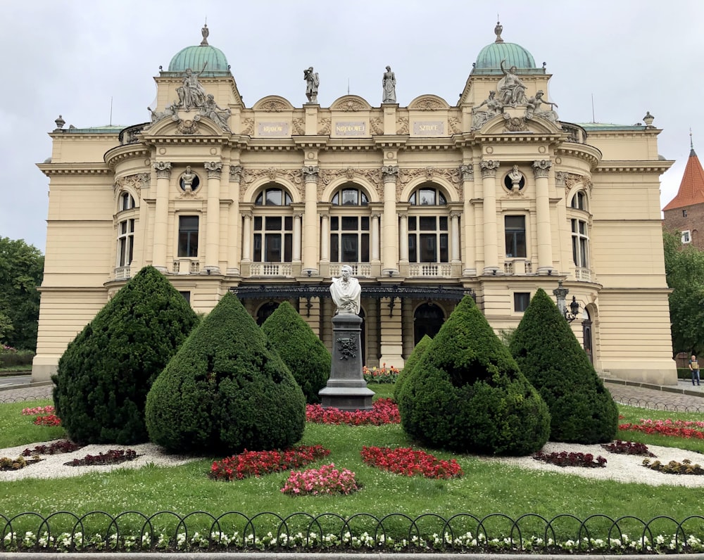 a large building with a statue in front of it