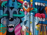 a mural of a cat and a mouse on a building