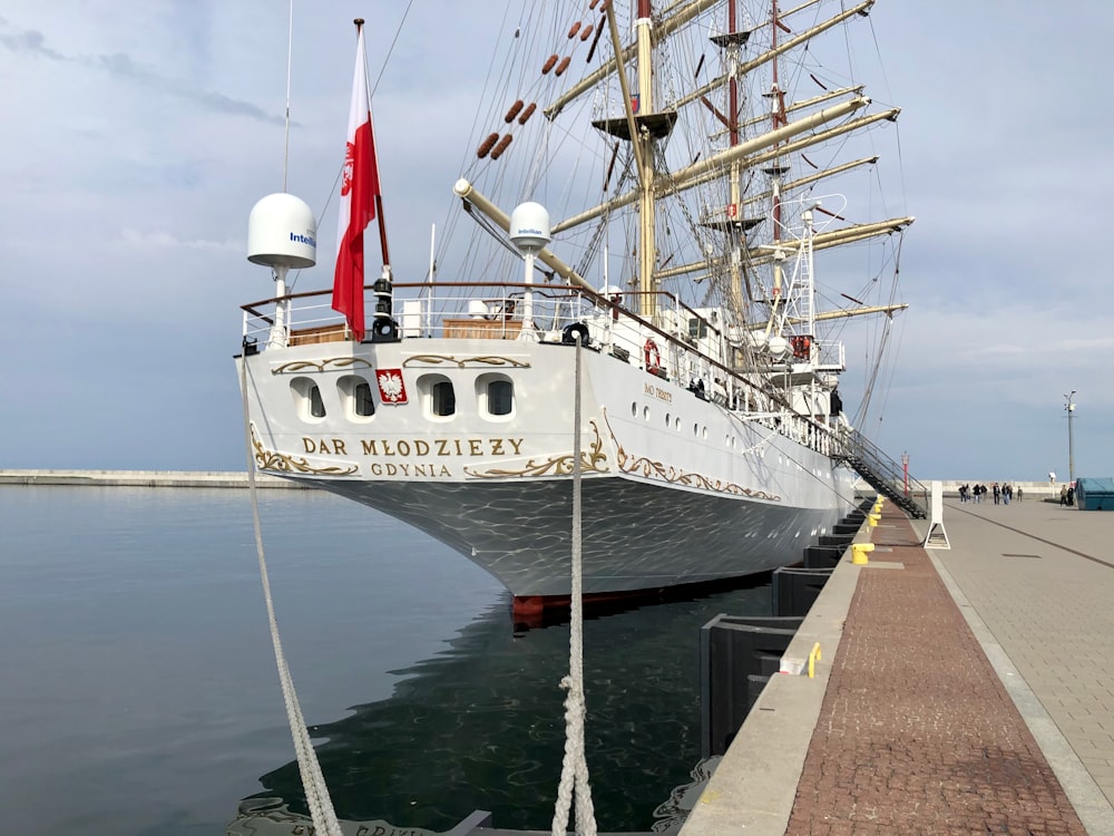 a large white boat docked at a pier