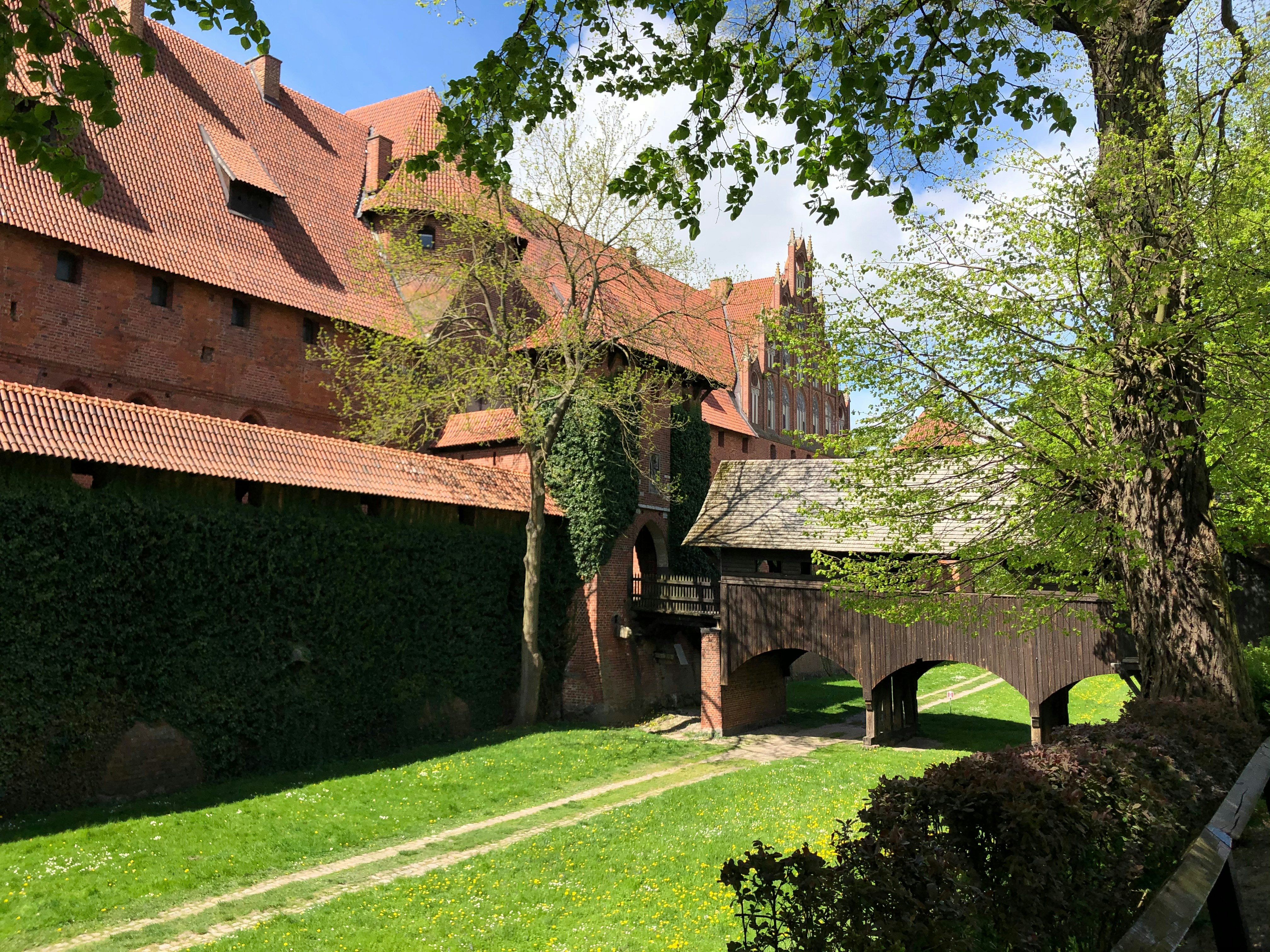 a large brick building with a green lawn in front of it