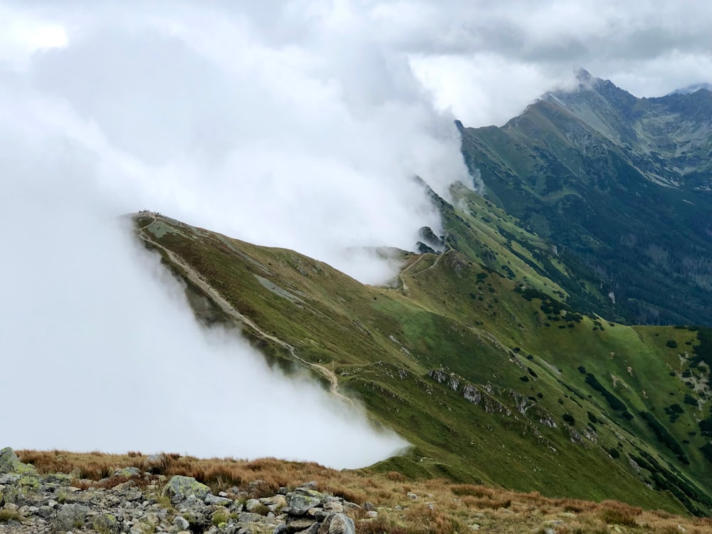 a view of a mountain range with low clouds