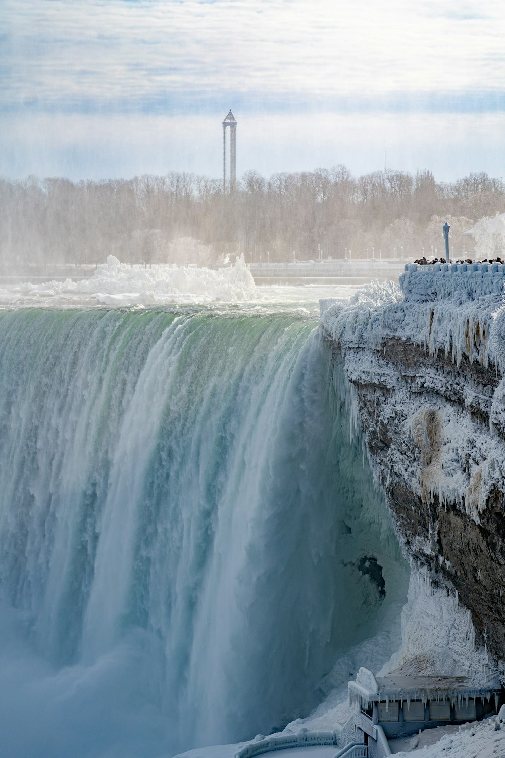 a man standing on the edge of a waterfall