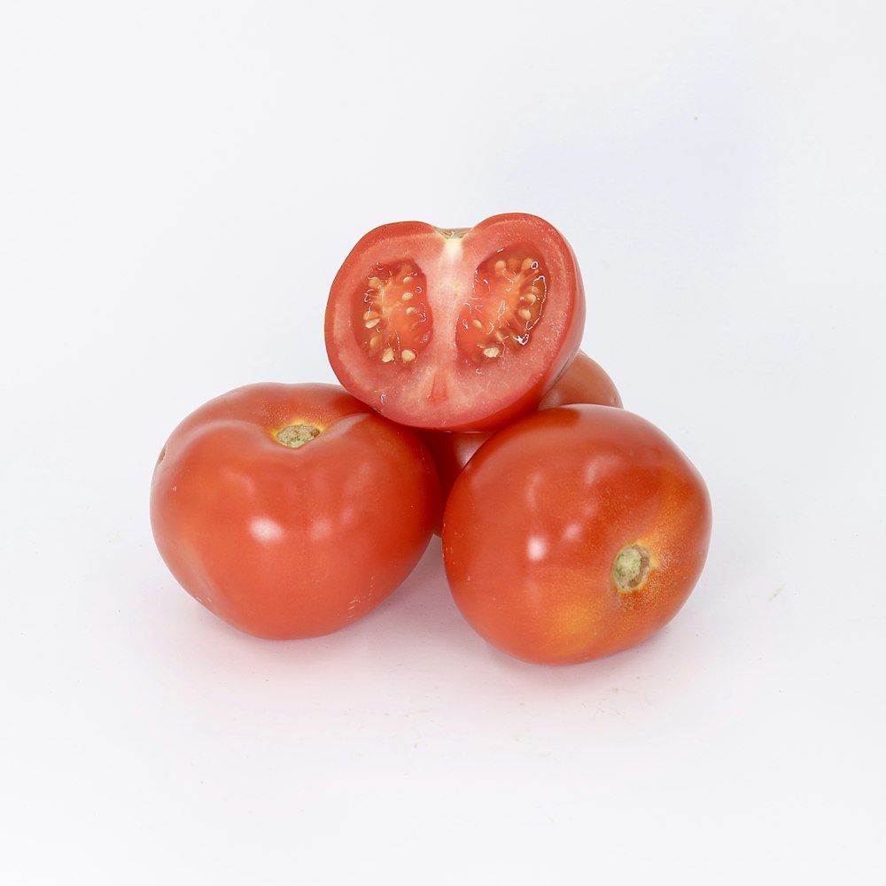 a group of three tomatoes sitting on top of each other