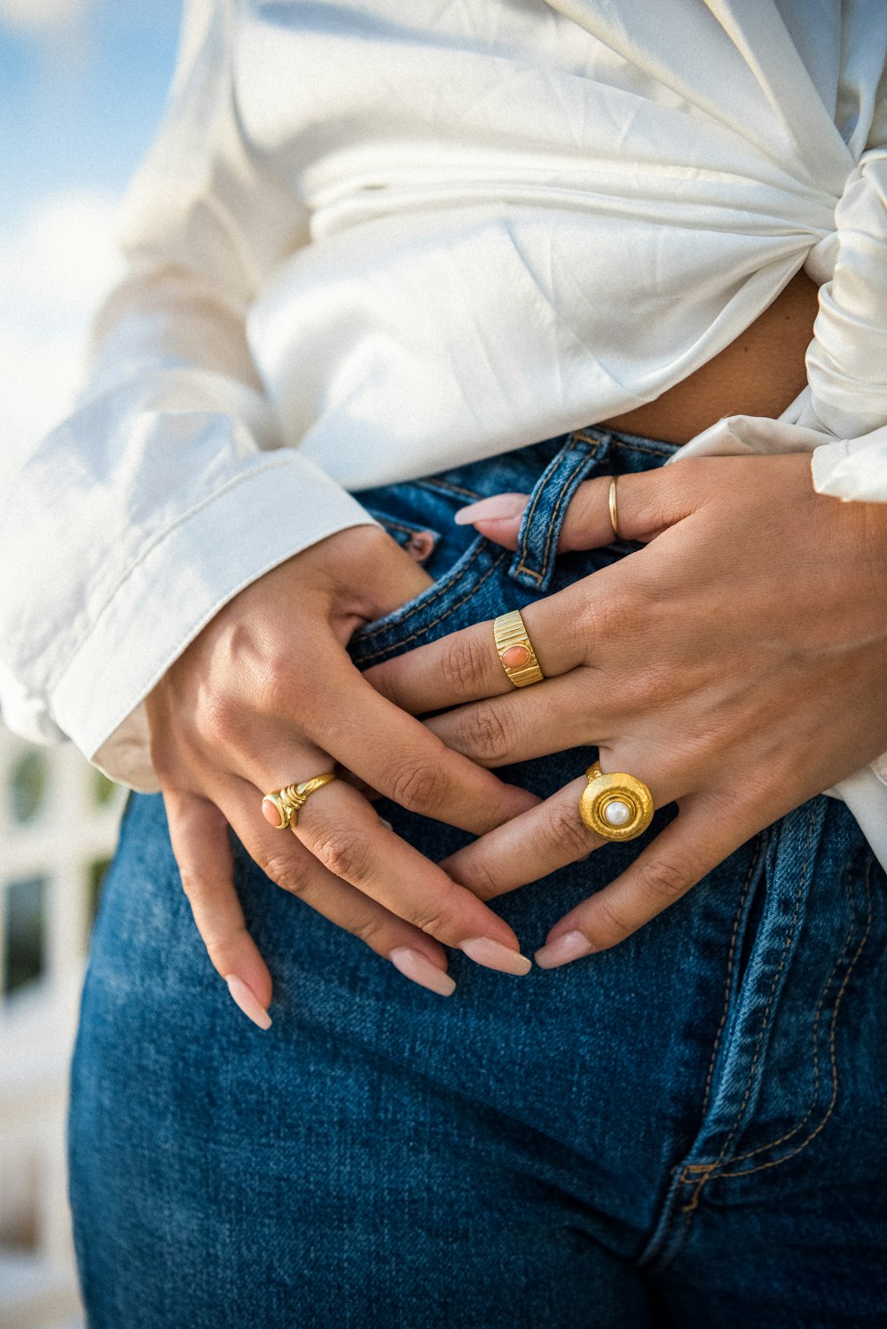 a woman wearing two gold rings on her stomach