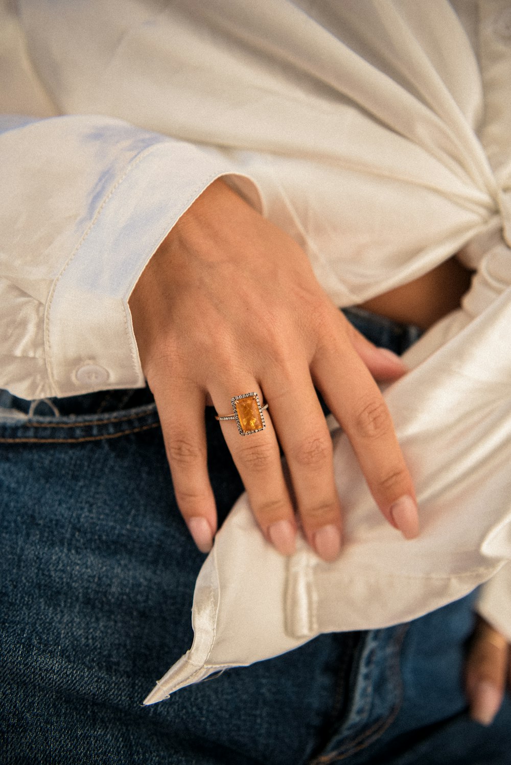 a person wearing a ring on their left hand