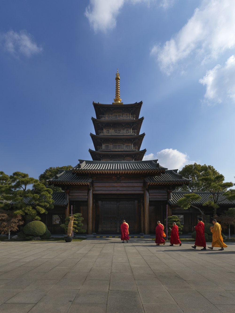 a group of people walking in front of a tall building