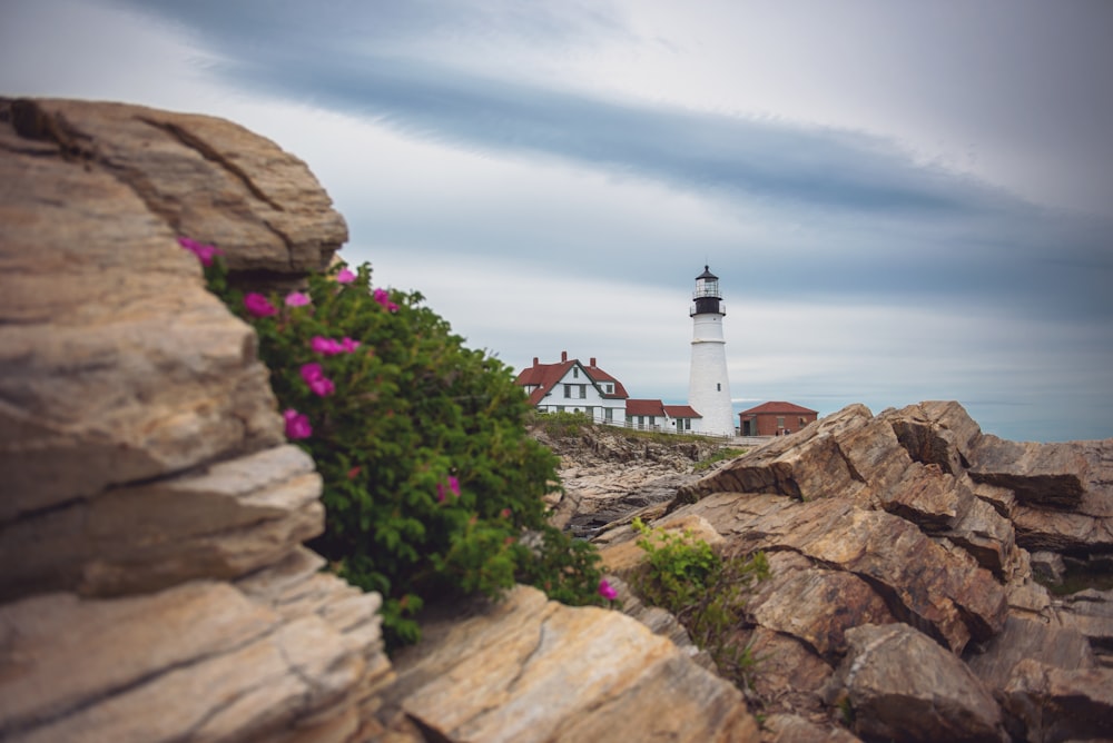 a view of a light house from a rocky outcropping