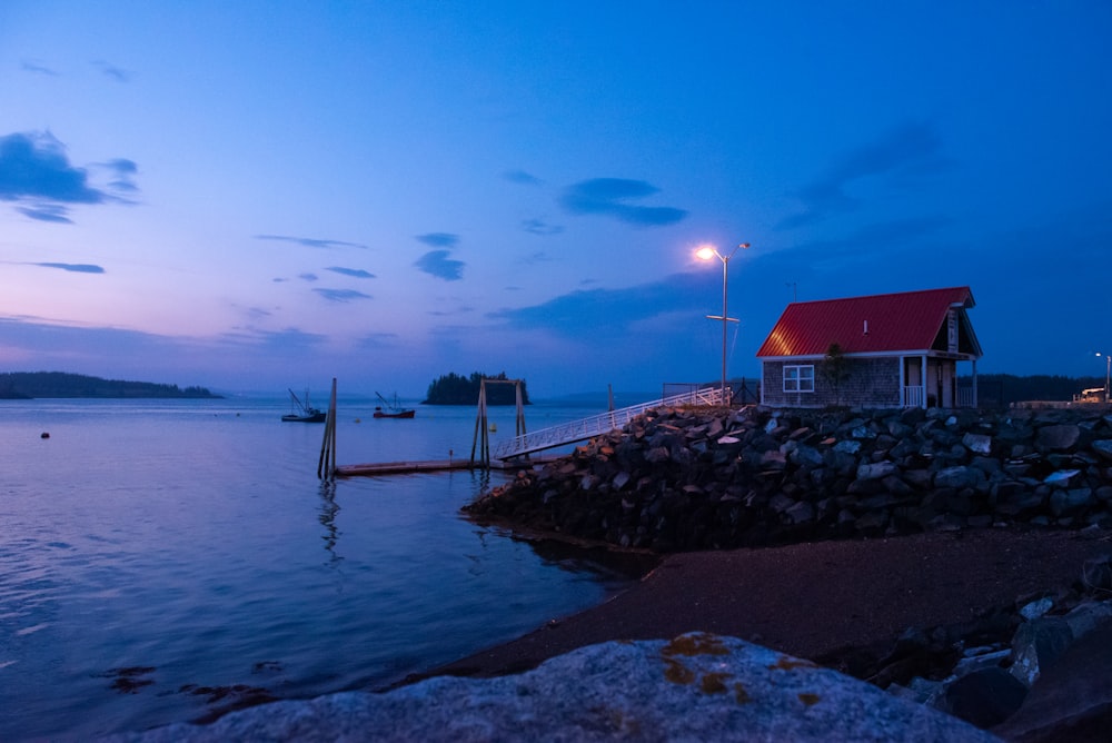 a house sitting on the shore of a body of water