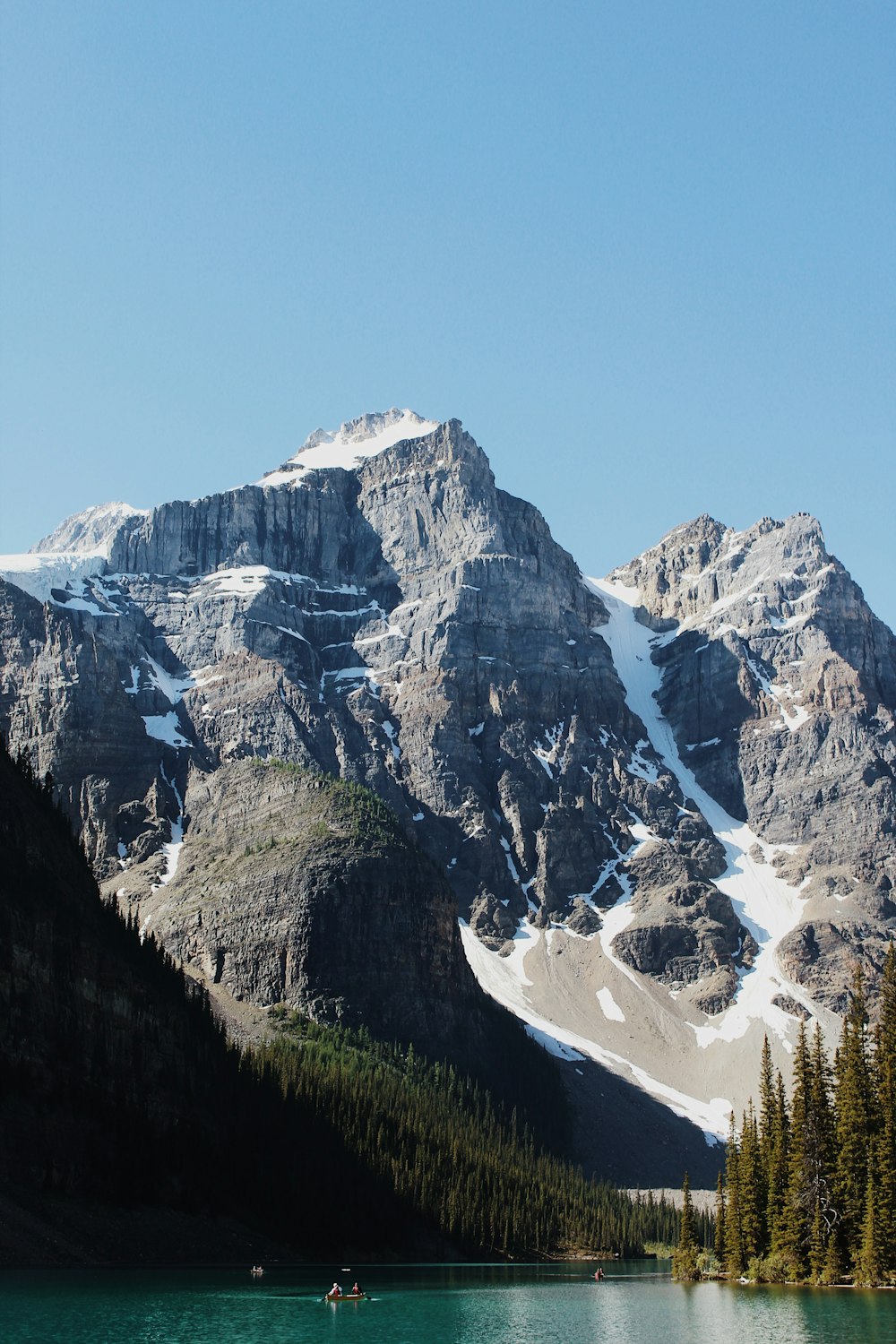 a mountain range with a lake in the foreground