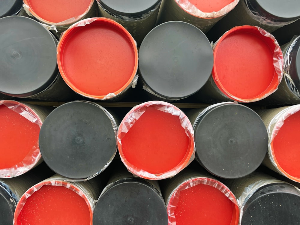 a pile of red and black paint sitting on top of each other