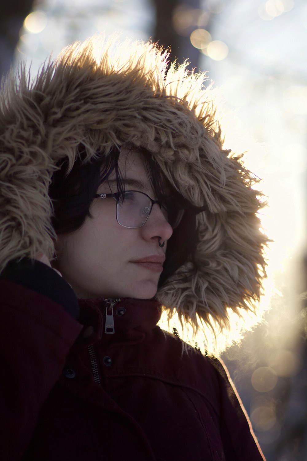 a woman wearing a fur hat and glasses