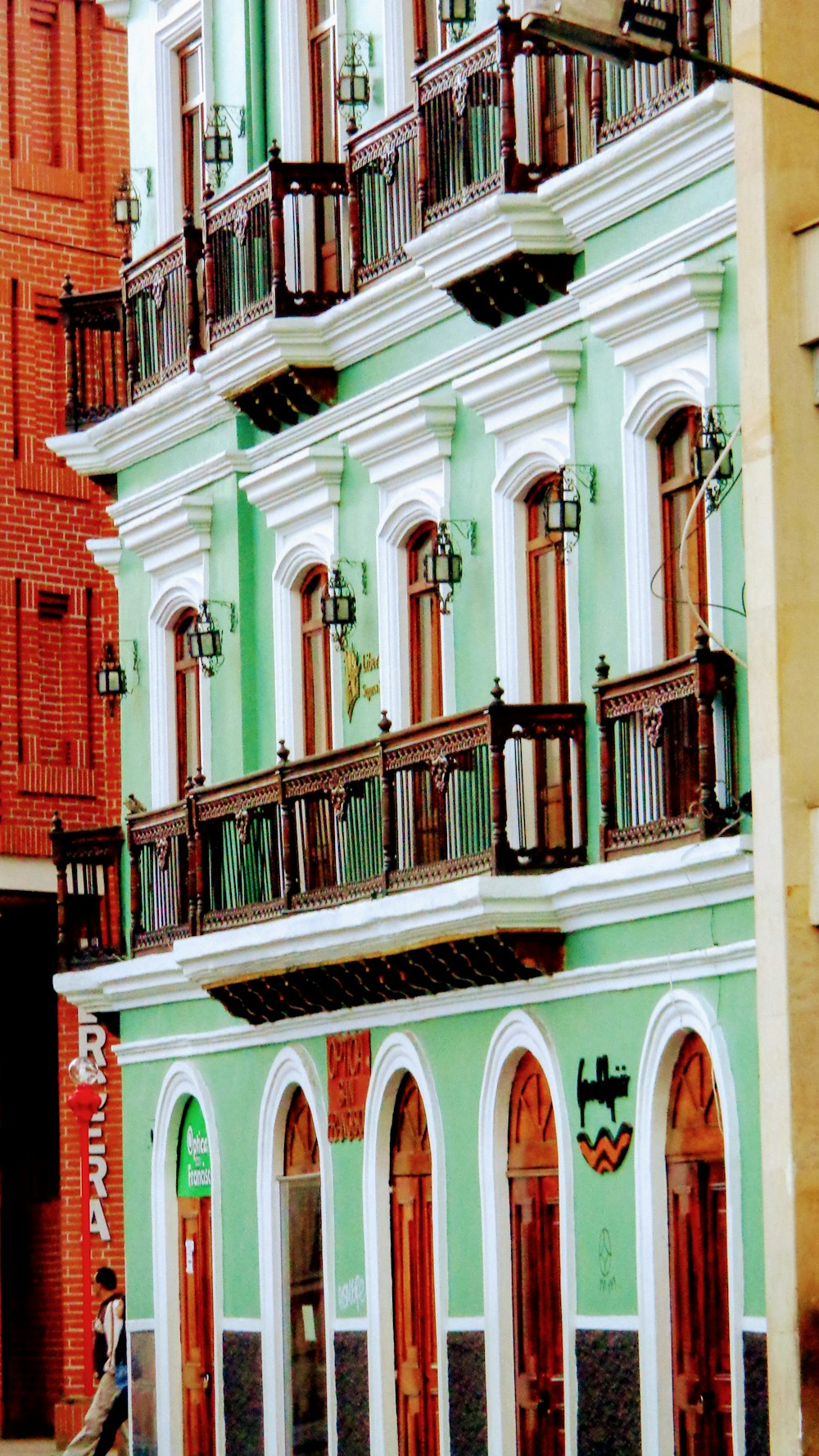 a green building with balconies and balconies on the balconies