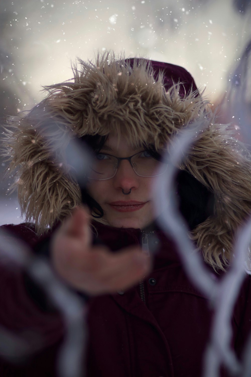 a woman wearing glasses and a fur hat