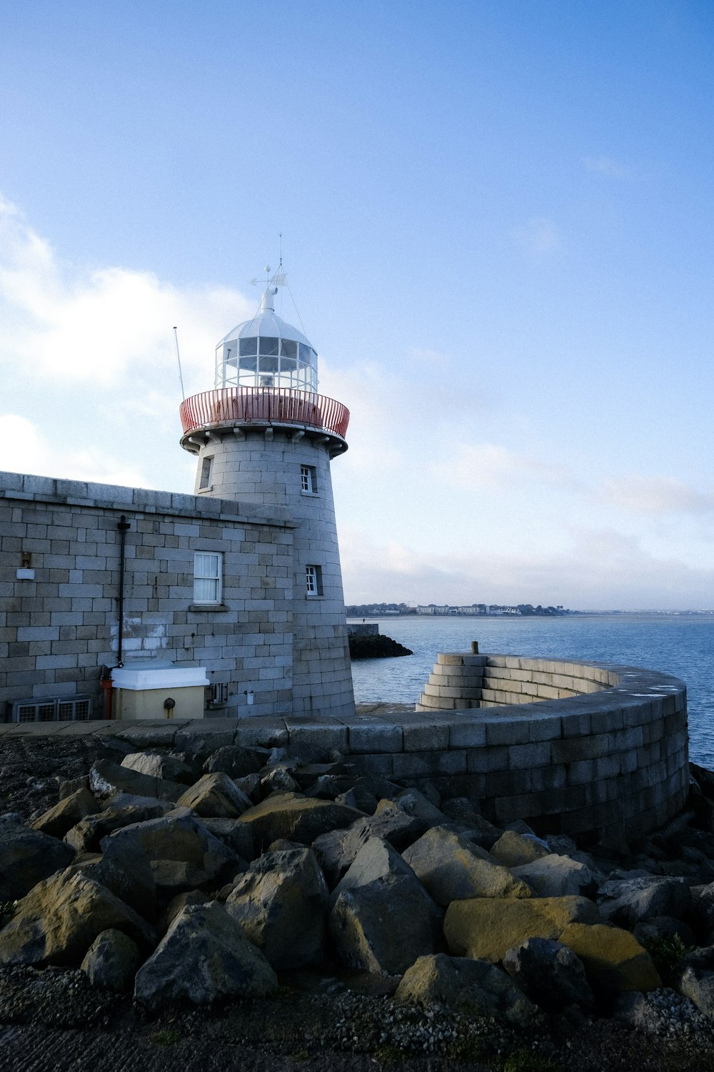 a light house sitting on top of a rocky shore