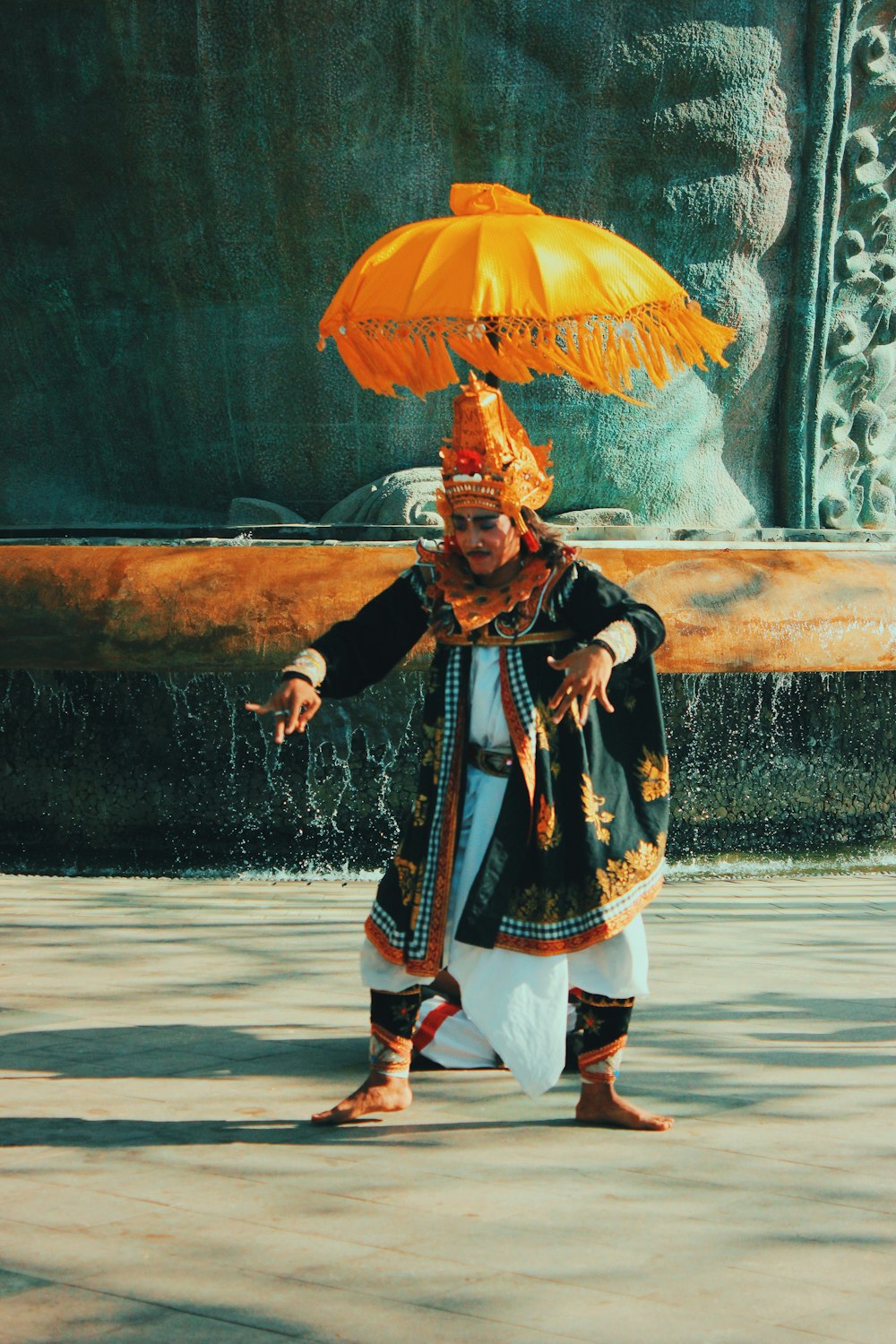 a man in a costume is holding an umbrella