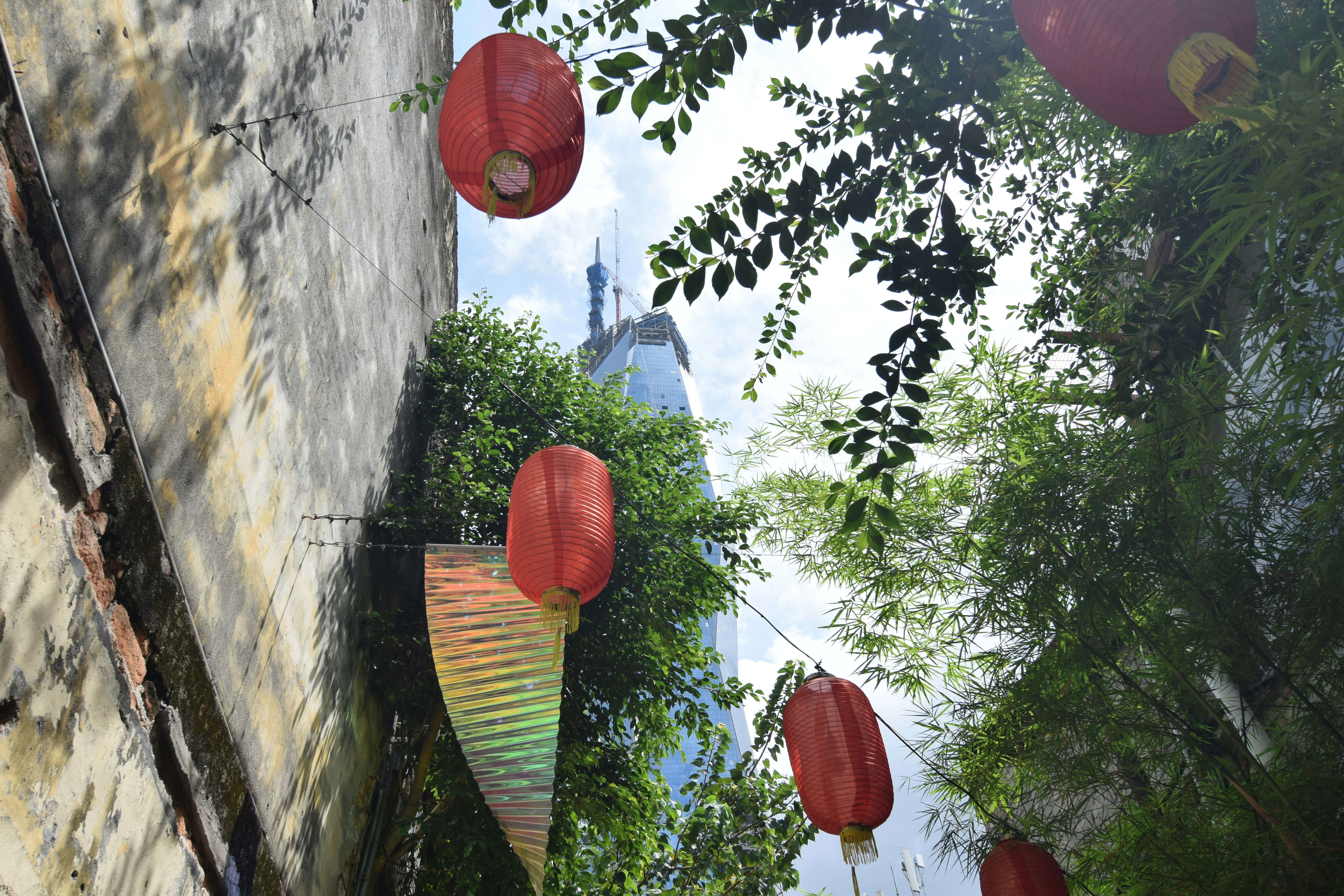 a bunch of red lanterns hanging from the side of a building