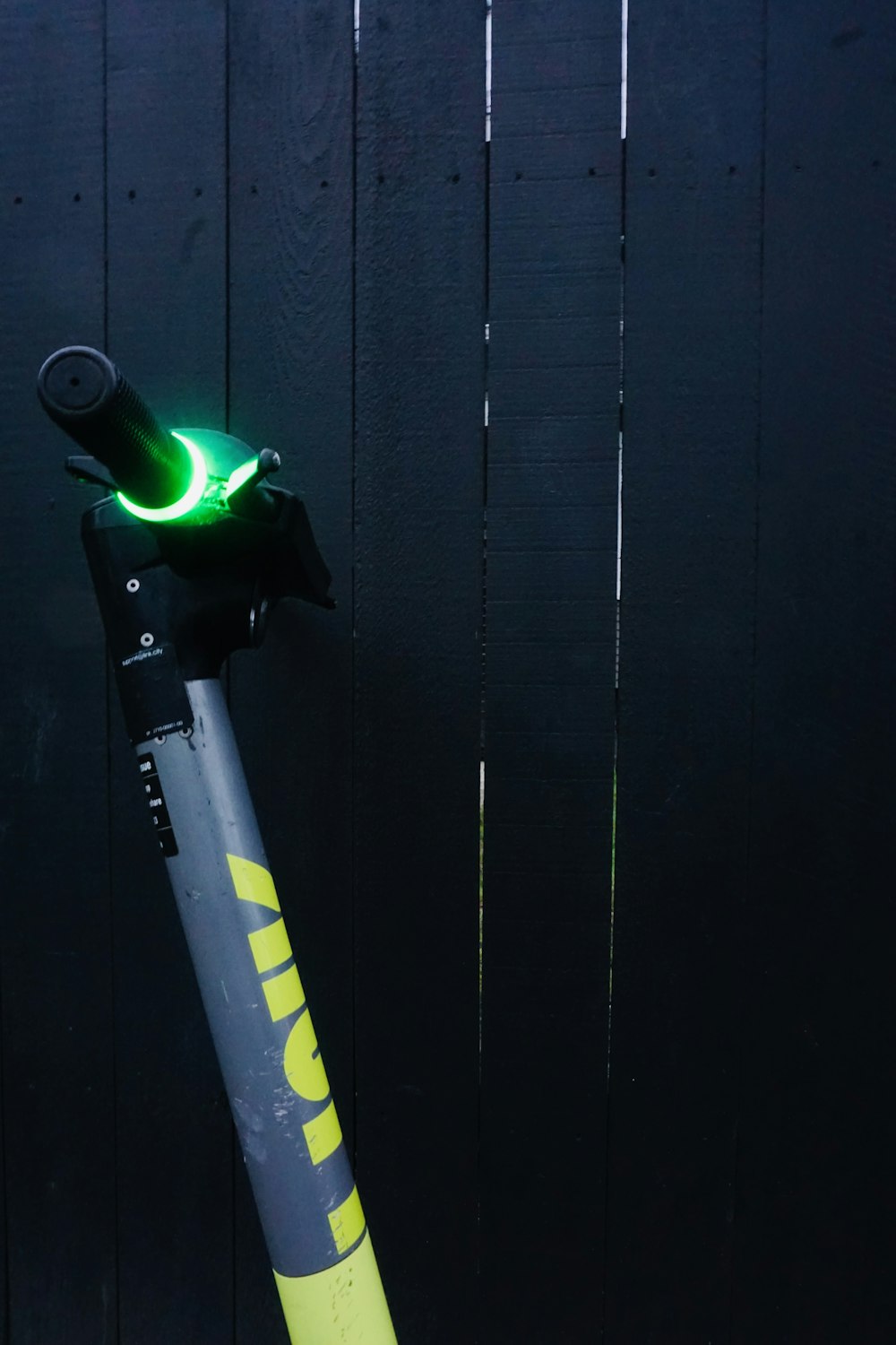 a close up of a bike with a green light on it
