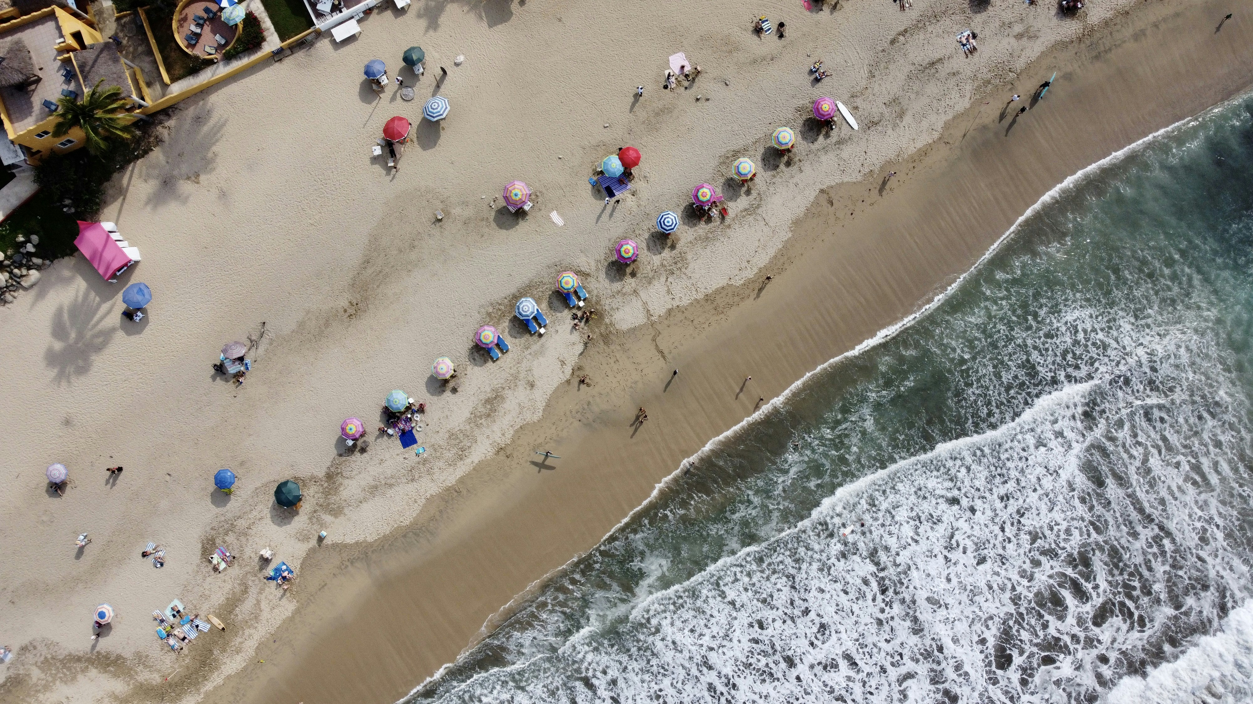 An aerial view of people walking on the beach photo – Free Nature Image ...