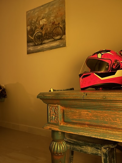 A vintage motorcycle helmet with warm colors and wooden accents.