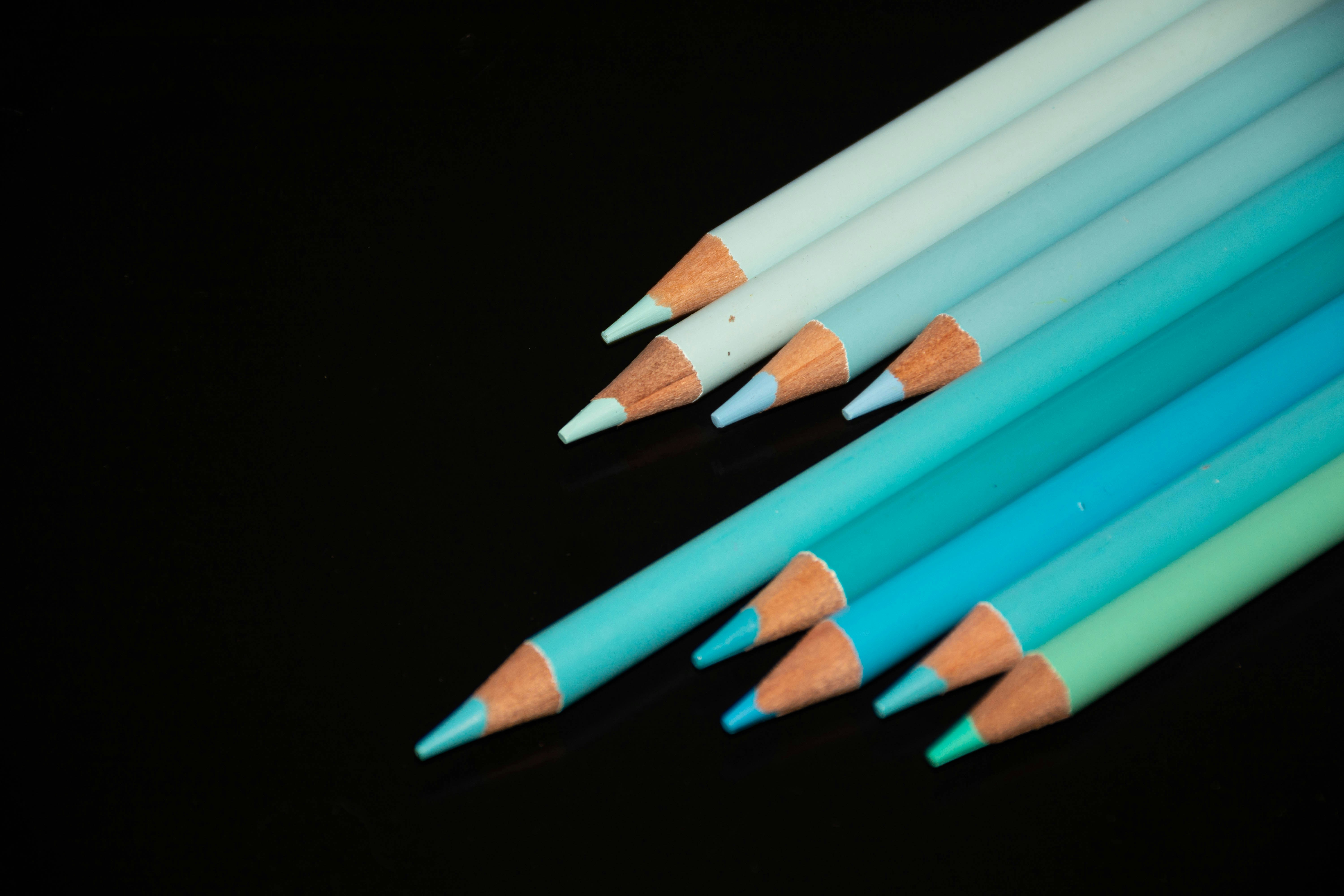a close up of a group of colored pencils