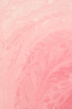 Swirling patterns of pastel pink and cream create a marbled effect, with soft textures and gentle curves throughout the composition.