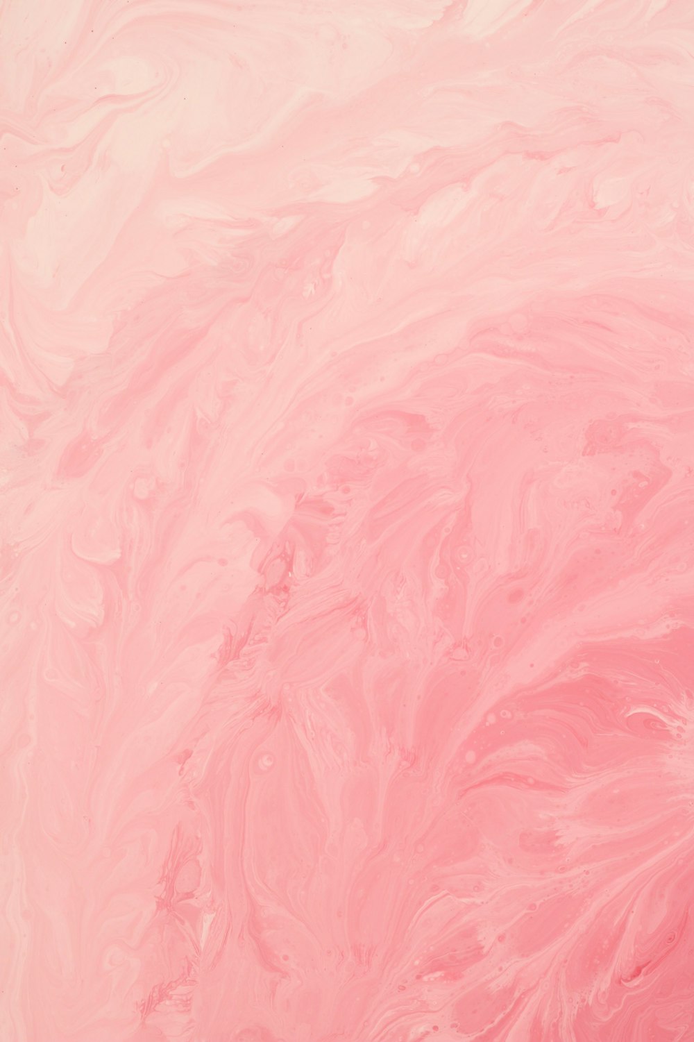 a close up of a pink and white background