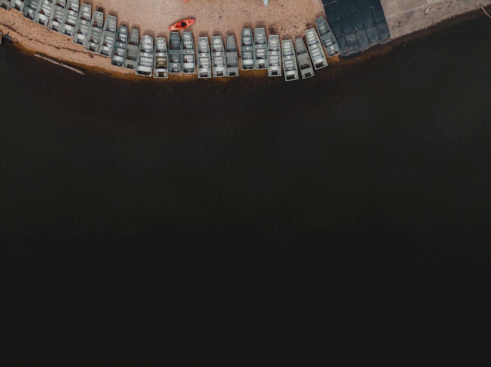 an aerial view of a parking lot next to a body of water