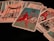 A collection of tarot cards is spread out, featuring various illustrated scenes and symbols. Dominant cards include a figure on horseback holding a staff, and another card shows a structure with four tall poles surrounding it.
